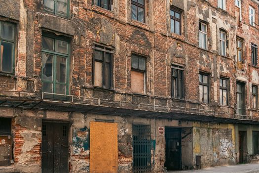 Explore the aged facade of an abandoned building in Łódź, Poland, showcasing urban decay and historical architecture.