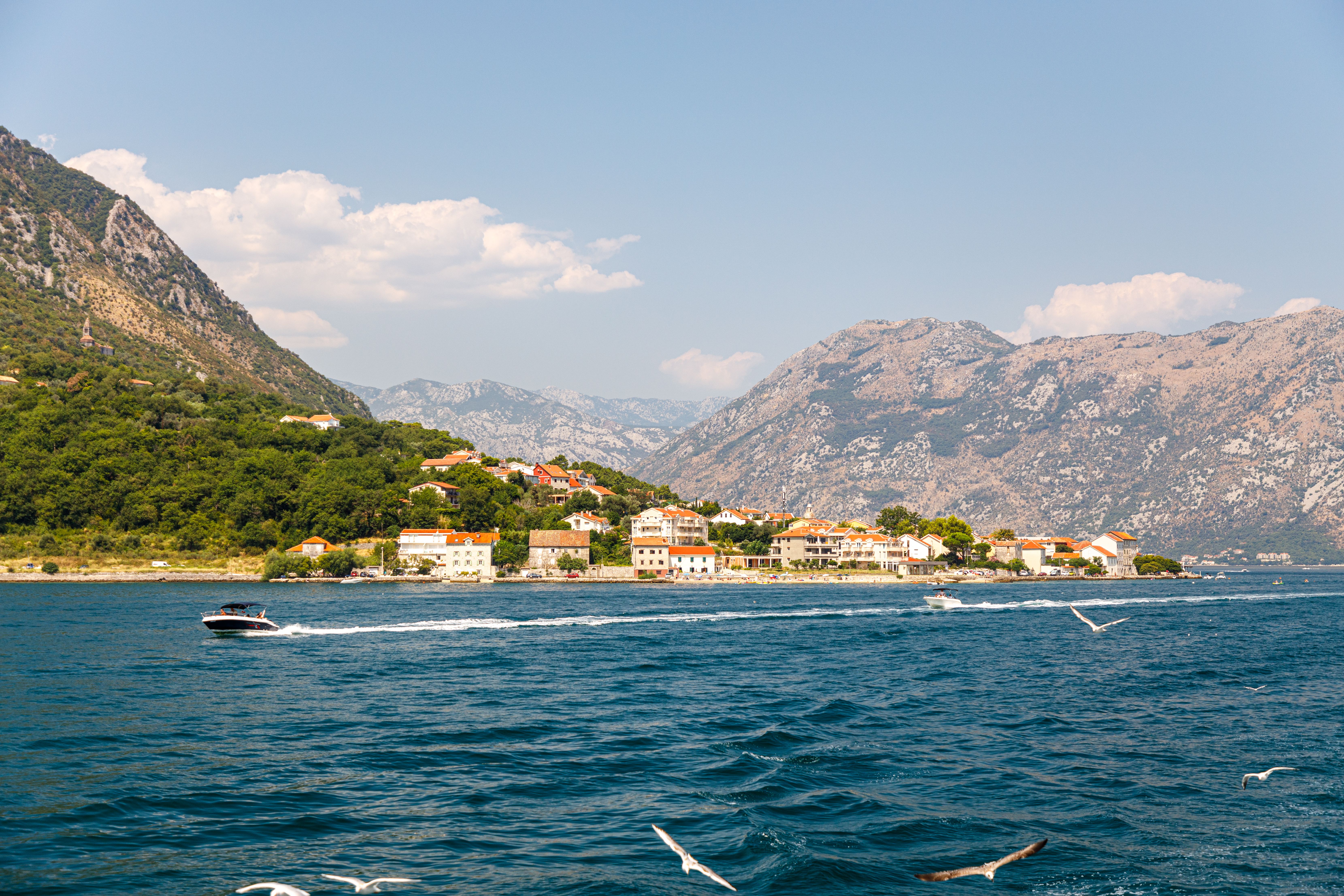 Scenic View of Coastal Town and Mountains · Free Stock Photo