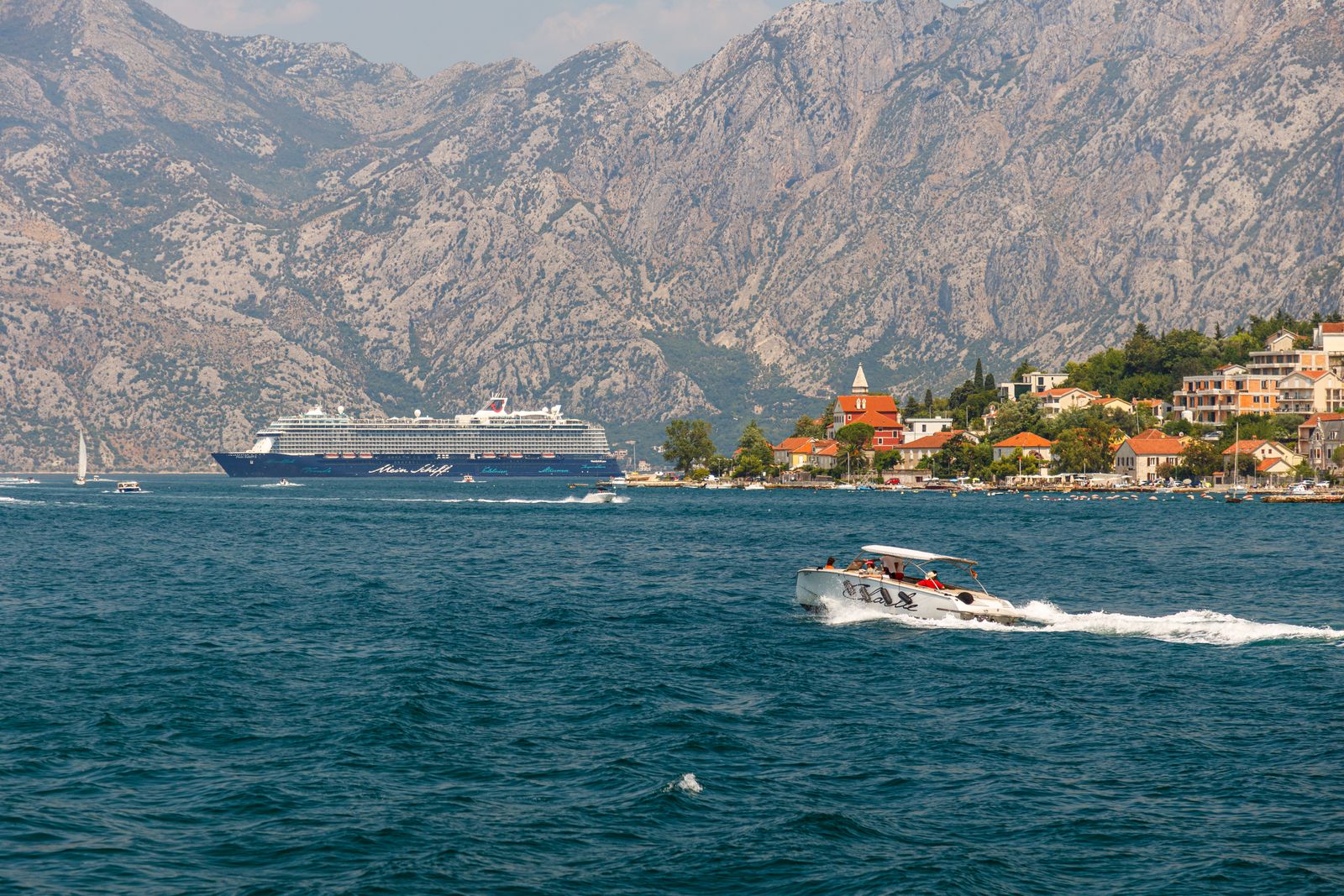 Cruise ship beside a scenic coastal destination