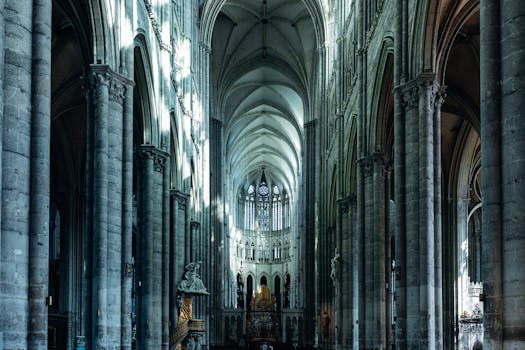 Explore the majestic Gothic architecture of Amiens Cathedral with its towering columns and stained glass windows.