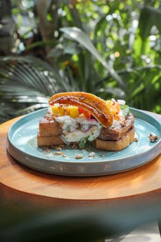 A vibrant plate of French toast topped with tropical fruits and cream, captured outdoors in Bali.