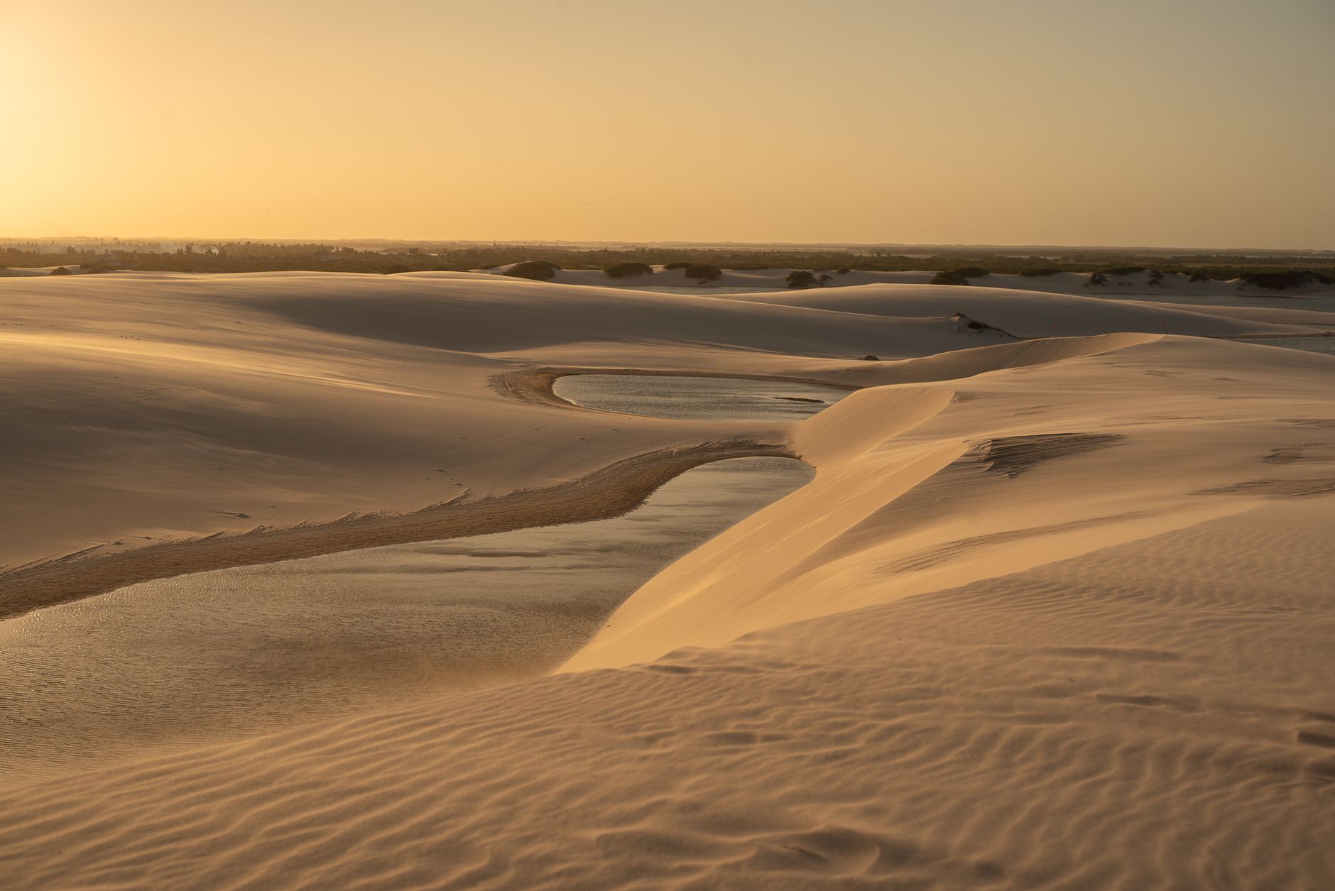 Golden sunset over tranquil sand dunes in Brazil's stunning landscape.