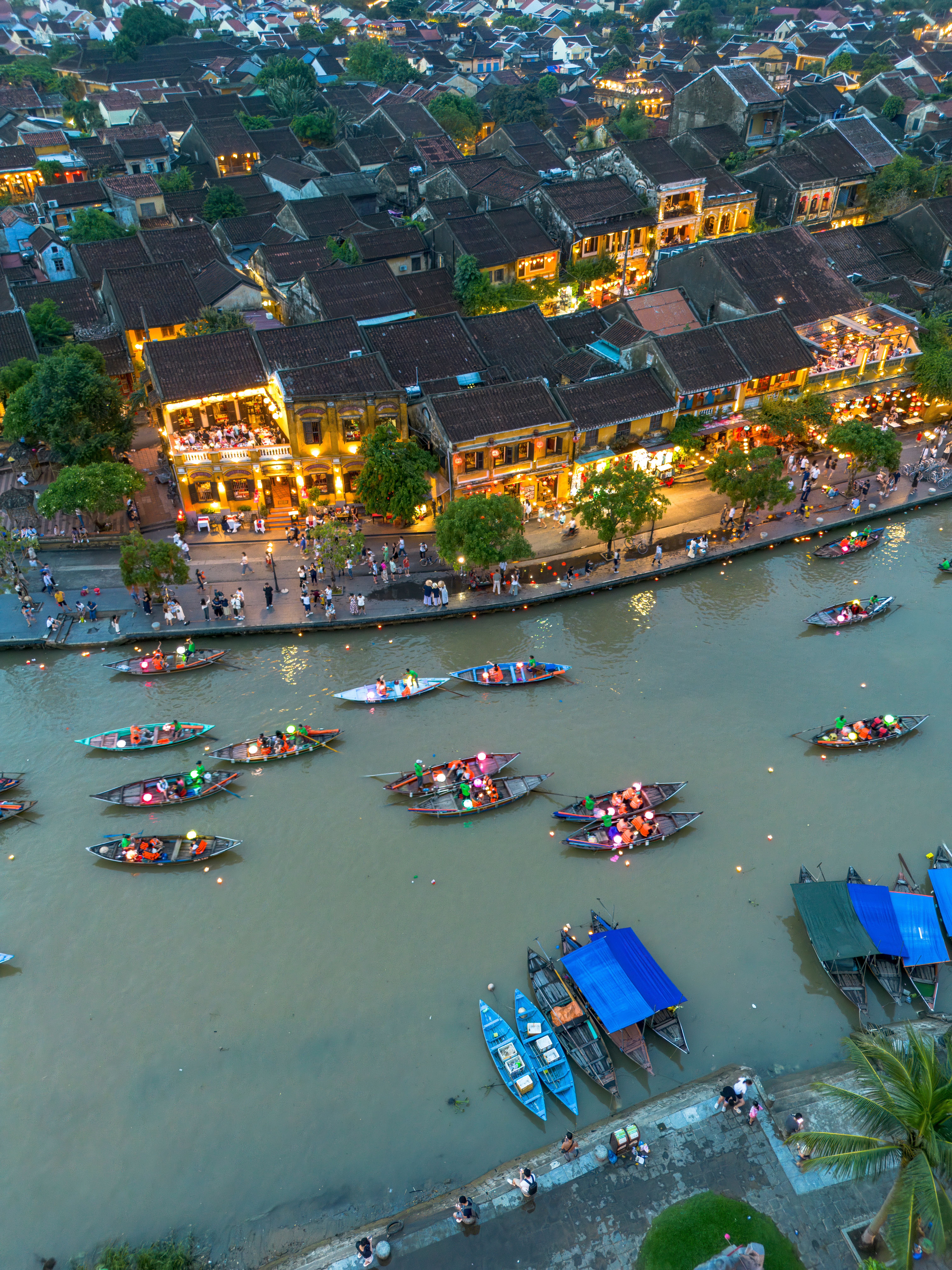 Aerial view of Hoi An's lantern-lit boat festival on the Thu Bon River at night, Vietnam