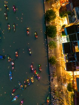 Stunning aerial view of lantern-lit boats on a river in Hội An, Vietnam, creating a magical nighttime scene.