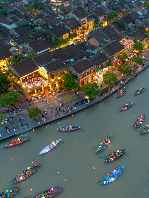 Free A vibrant aerial view of boats with lanterns on the river in Hội An, Vietnam by night. Stock Photo