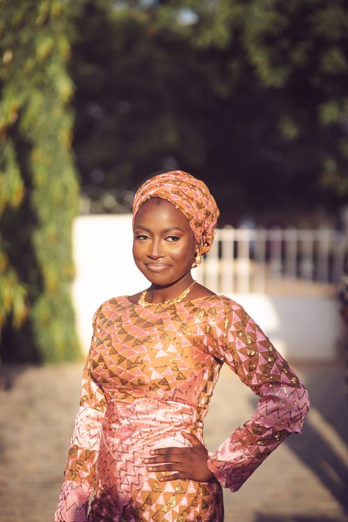 Free Confident woman in vibrant traditional dress posing outdoors, capturing cultural elegance. Stock Photo