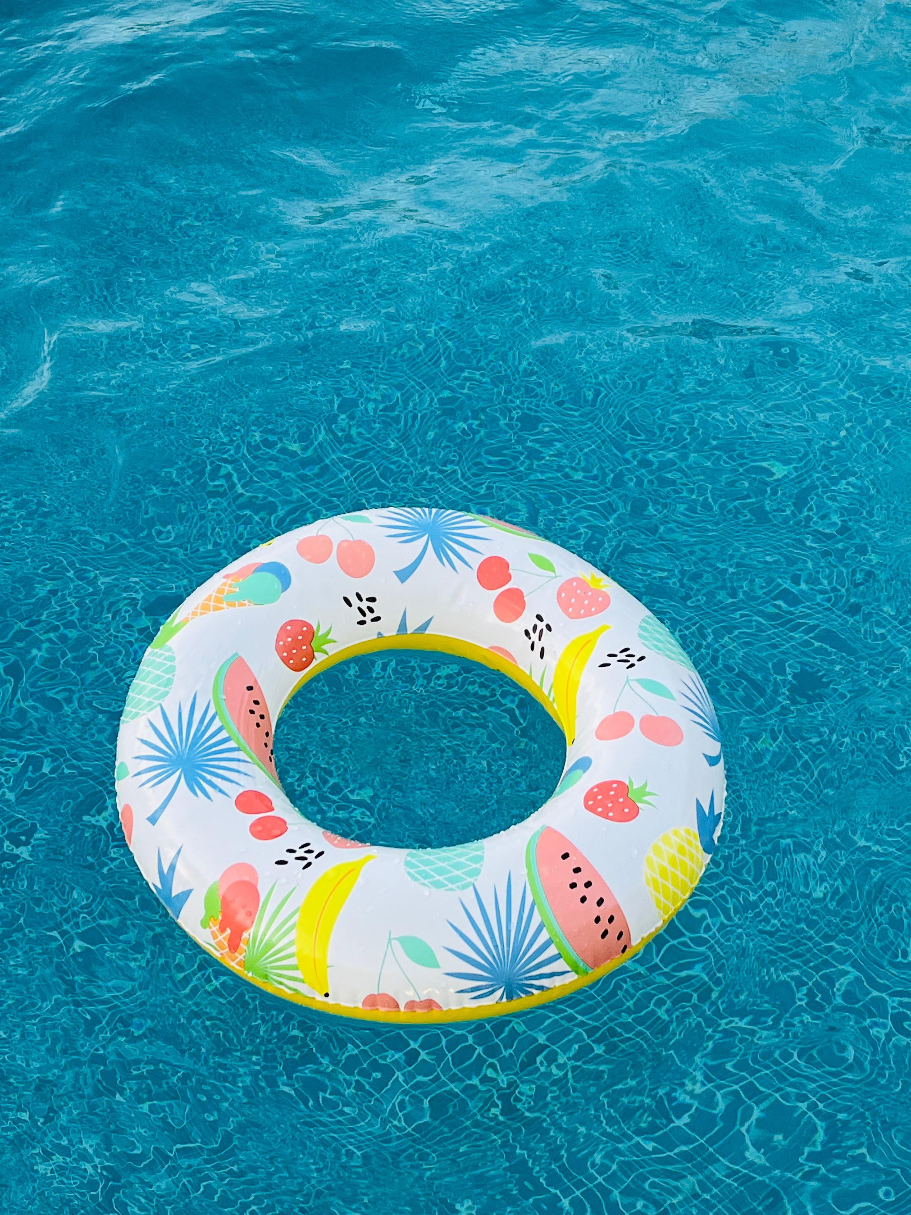 Colorful Inflatable Ring Floating in Pool · Free Stock Photo