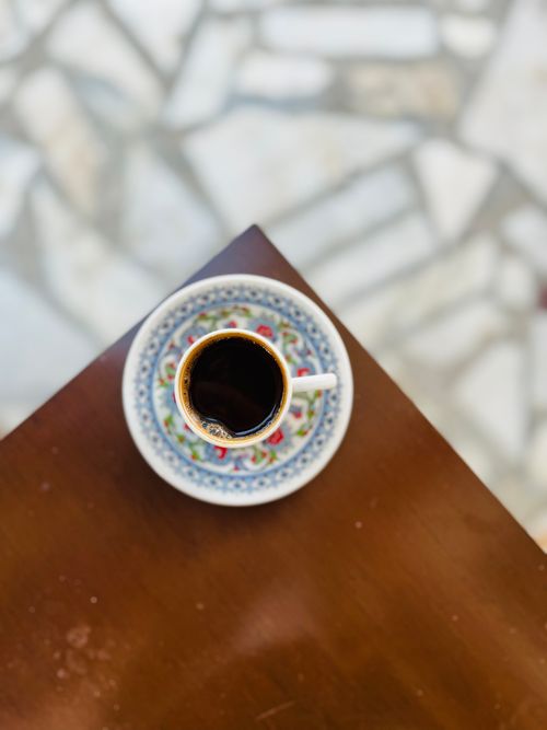 Free Top view of a traditional Turkish coffee in an intricate cup on a wooden table. Stock Photo