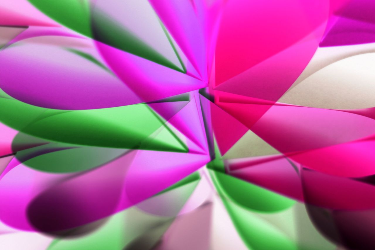 a vibrant abstract pattern of folded colorful paper in pink and green