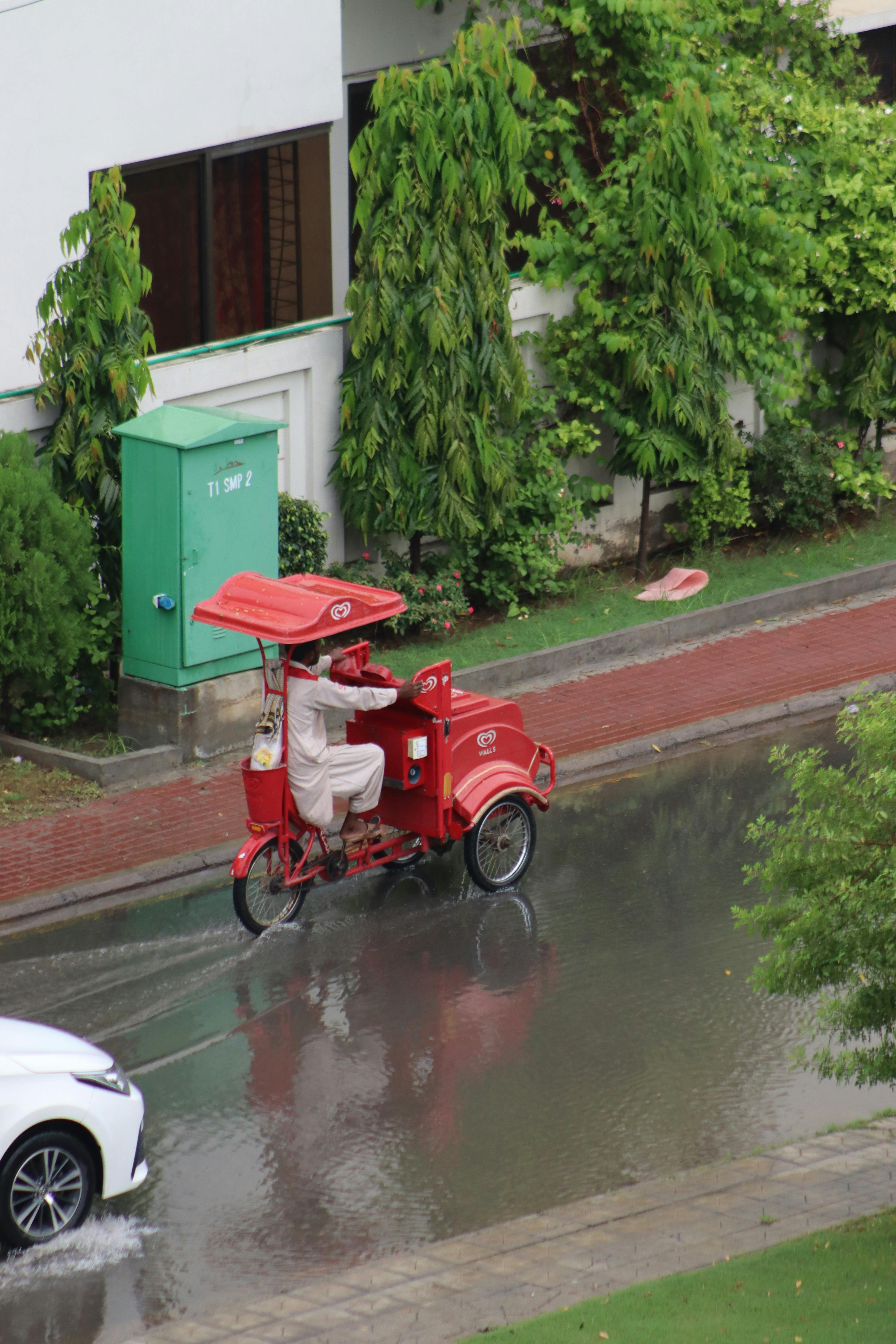 Red Auto Rickshaw on Rainy Street · Free Stock Photo