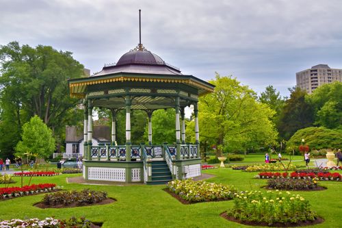 Free Green gazebo amidst colorful flower beds in Halifax Public Gardens. Stock Photo