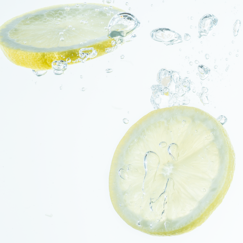 Free Citrus slices splashing in water, showcasing freshness and zest. Perfect for healthy lifestyle themes. Stock Photo
