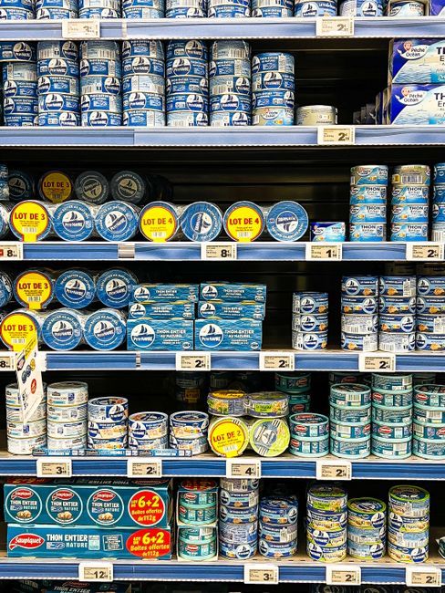 A clean and trustworthy seafood specialty shop in Mong Cai, customers inspecting products, transparent pricing signs, organized shelves, realistic retail documentary style