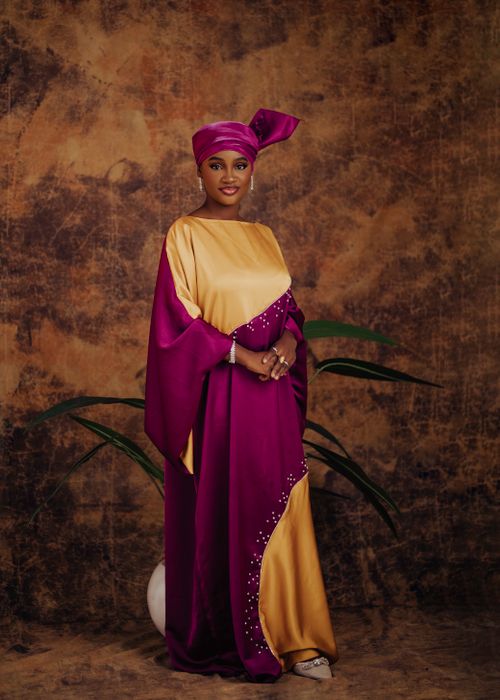 Free Portrait of an African woman in colorful traditional Nigerian attire with a vibrant headscarf. Stock Photo