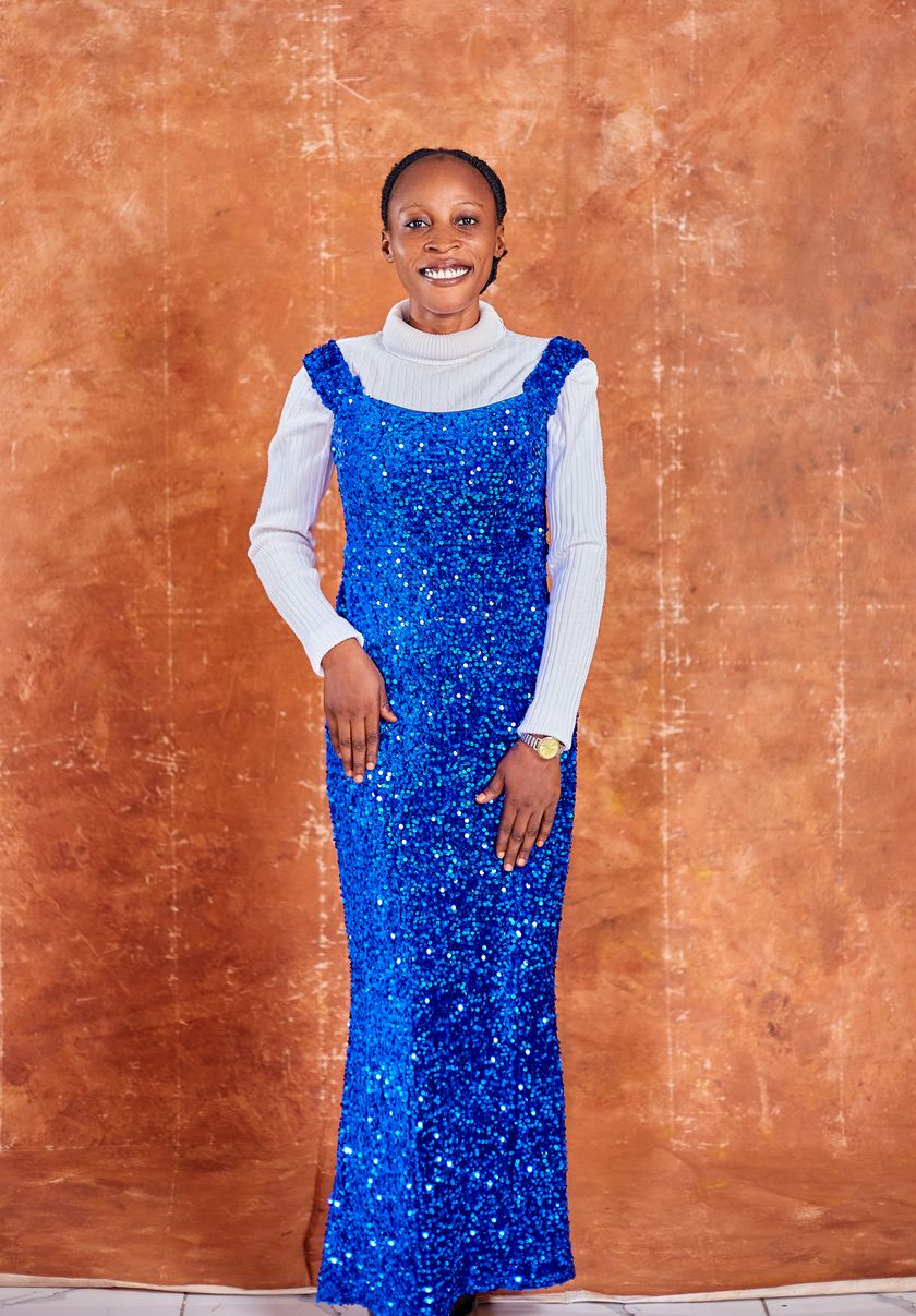 A floor-length sequinned party dress worn full length