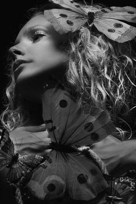 Captivating monochrome portrait of a woman adorned with butterflies in Kyiv, Ukraine.