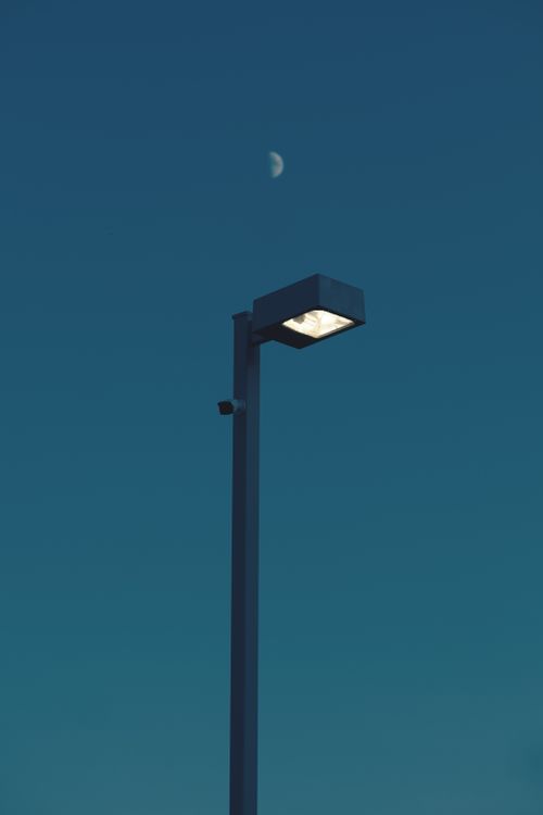 Free A serene shot of a streetlight beneath a moonlit sky in Waterloo, Canada. Stock Photo