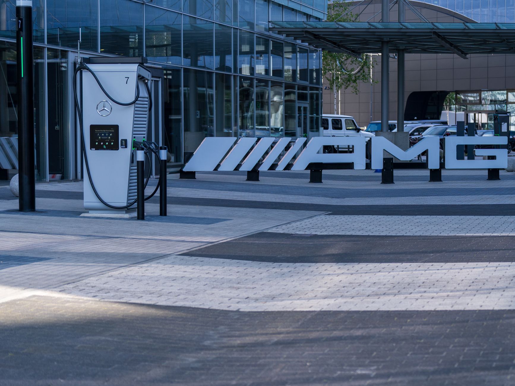 Electric vehicle charging station at a modern business complex featuring sleek architectural design.