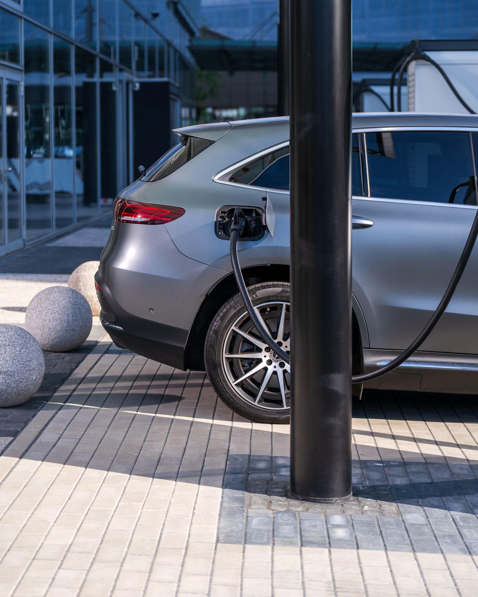 Electric vehicle connected to a charging cable illustrating charging-hardware route into china