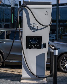 Luxury electric car at a high-power charging station in a modern urban setting.