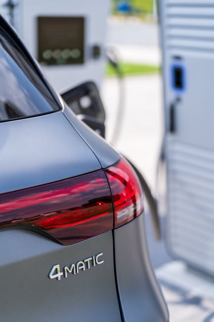 Photo by Mohamed B. Close-up of an electric vehicle being charged at a charging station outdoors.