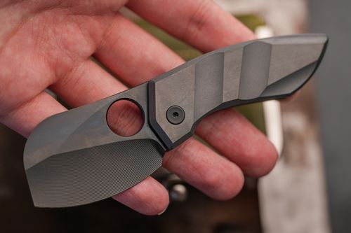Free Close-up of a compact tactical folding knife held in a hand, showcasing sleek design and craftsmanship. Stock Photo
