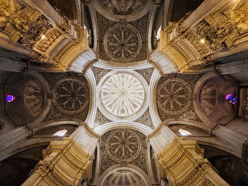 Free Intricate detailed view of a European cathedral ceiling showcasing stunning architecture. Stock Photo