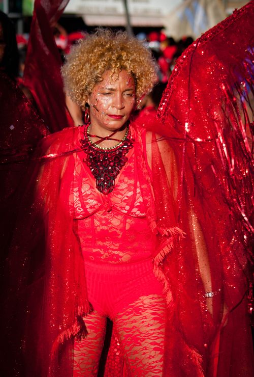 Free Woman in elaborate red lace costume at a lively carnival event, showcasing vibrant festival fashion. Stock Photo