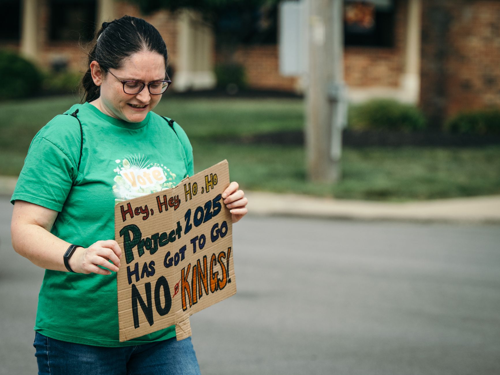 An adult protester displays a 'Project 2025 Has Got to Go' placard outdoors with determination.