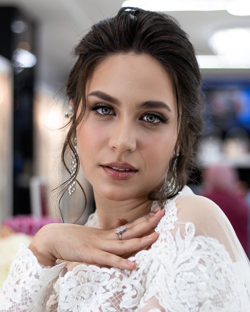 Free Beautiful young woman in bridal lace with elegant jewelry indoors, showcasing a serene expression. Stock Photo