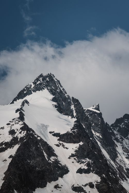 Free Majestic snowcapped mountain peak under a deep blue sky, perfect for nature and adventure themes. Stock Photo