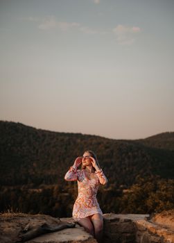 Woman enjoys a serene summer evening in Cluj-Napoca, Romania, soaking in the natural beauty.