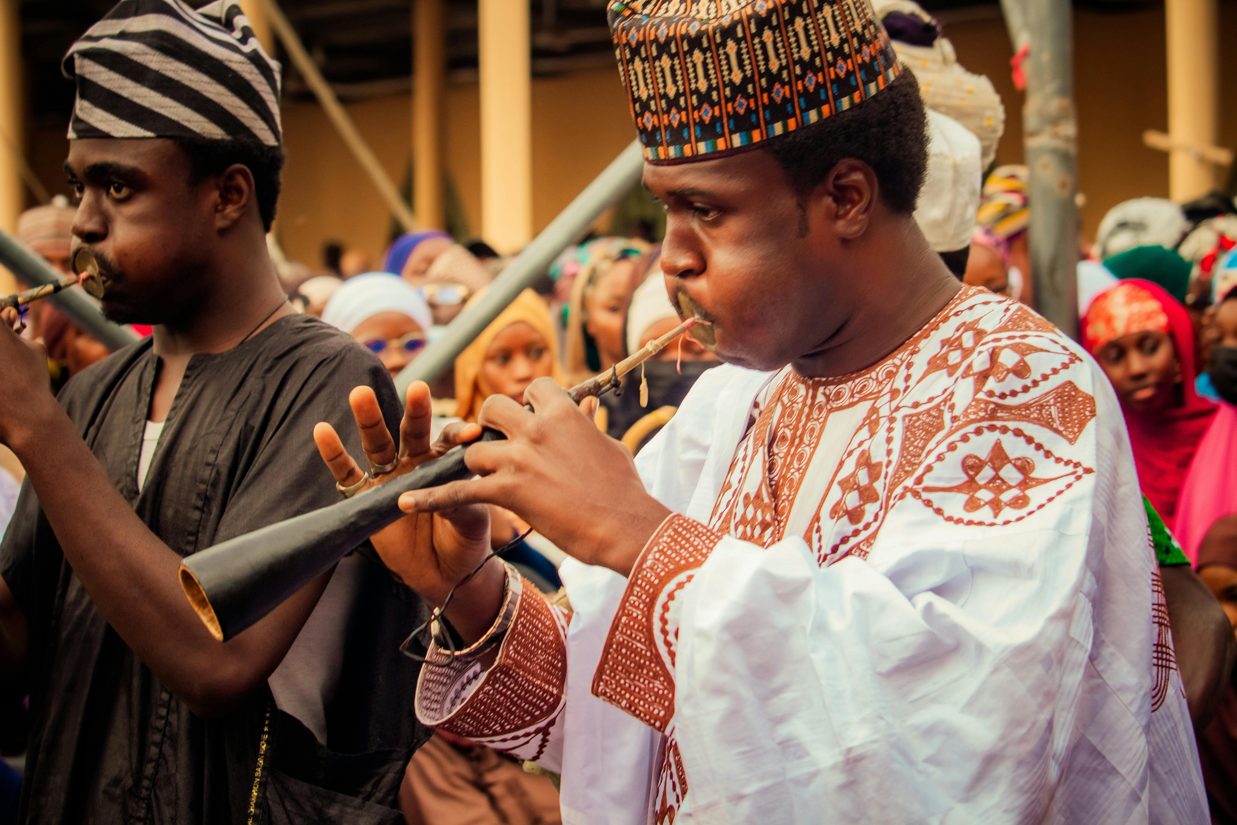 African musicians perform with traditional wind instruments during a cultural festival.