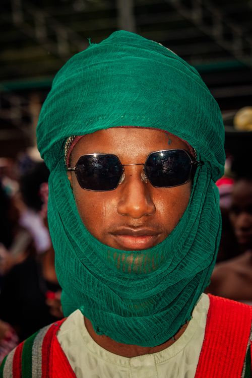 Free Vibrant portrait of individual wearing a green turban and sunglasses, showcasing cultural attire. Stock Photo