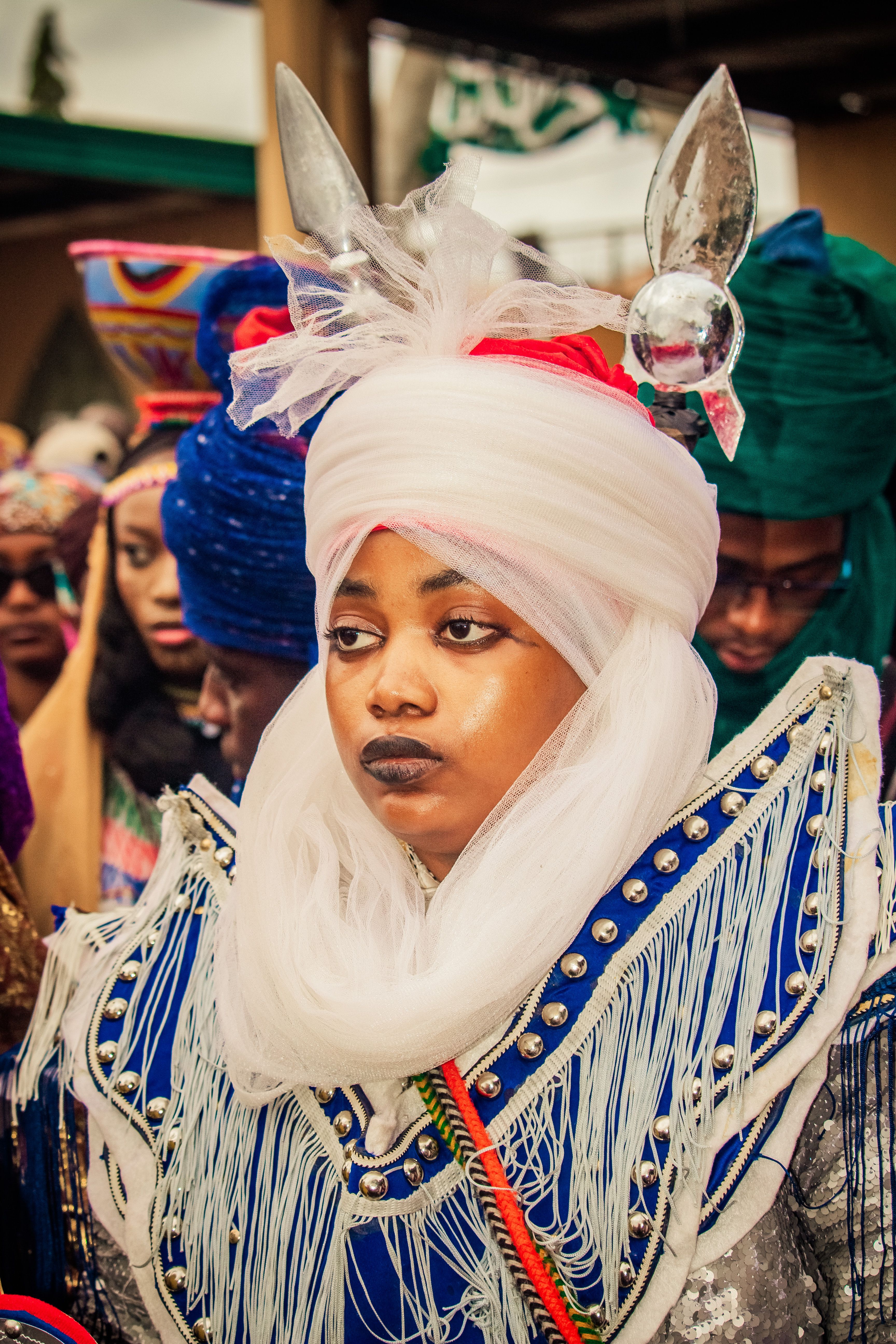 Colorful traditional African attire worn by individuals in a cultural festival setting.