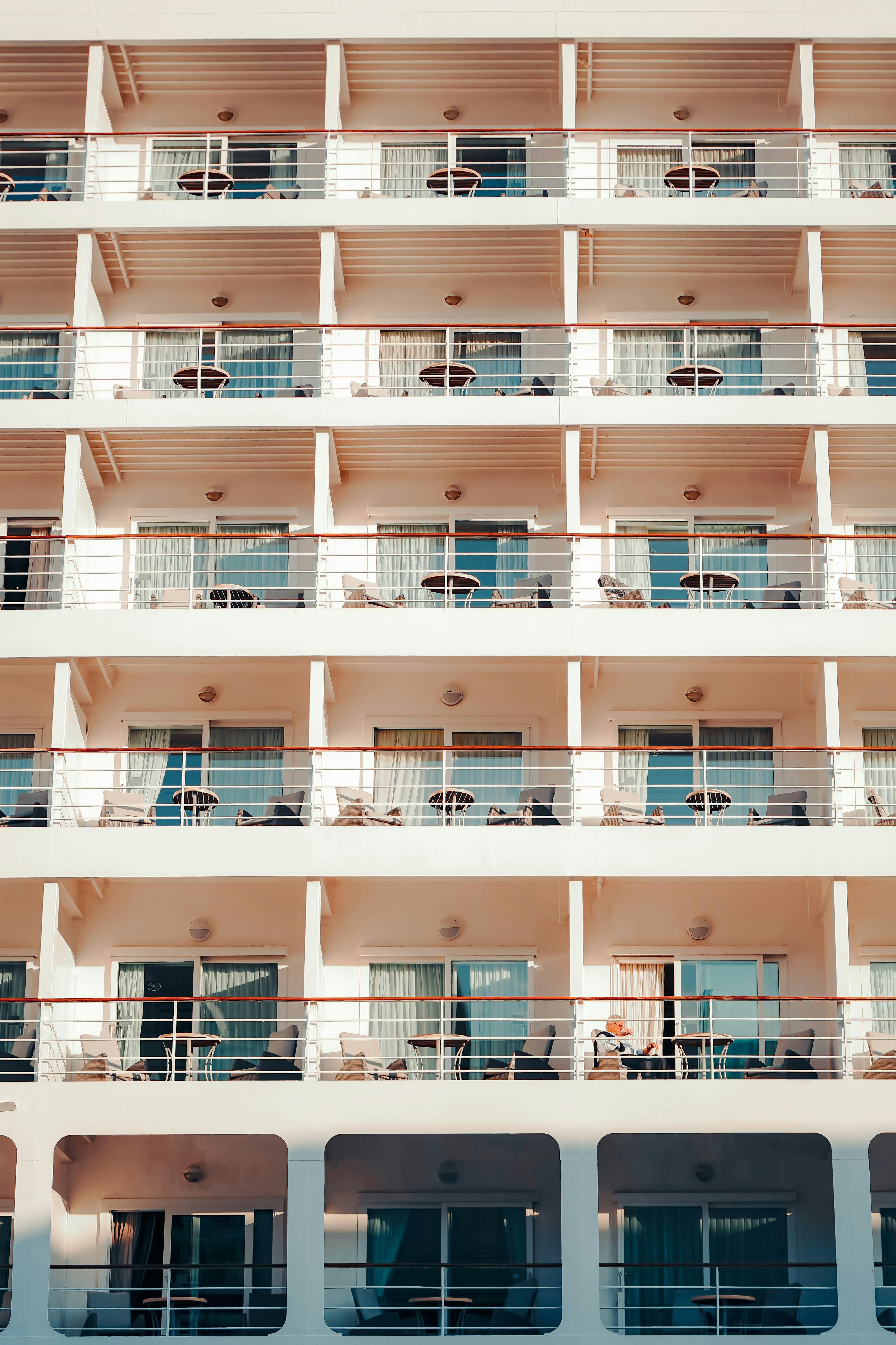 A symmetrical view of a multi-story hotel with balconies in İstanbul, Türkiye, under daylight.
