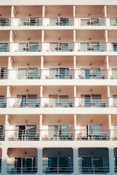A symmetrical view of a multi-story hotel with balconies in İstanbul, Türkiye, under daylight.