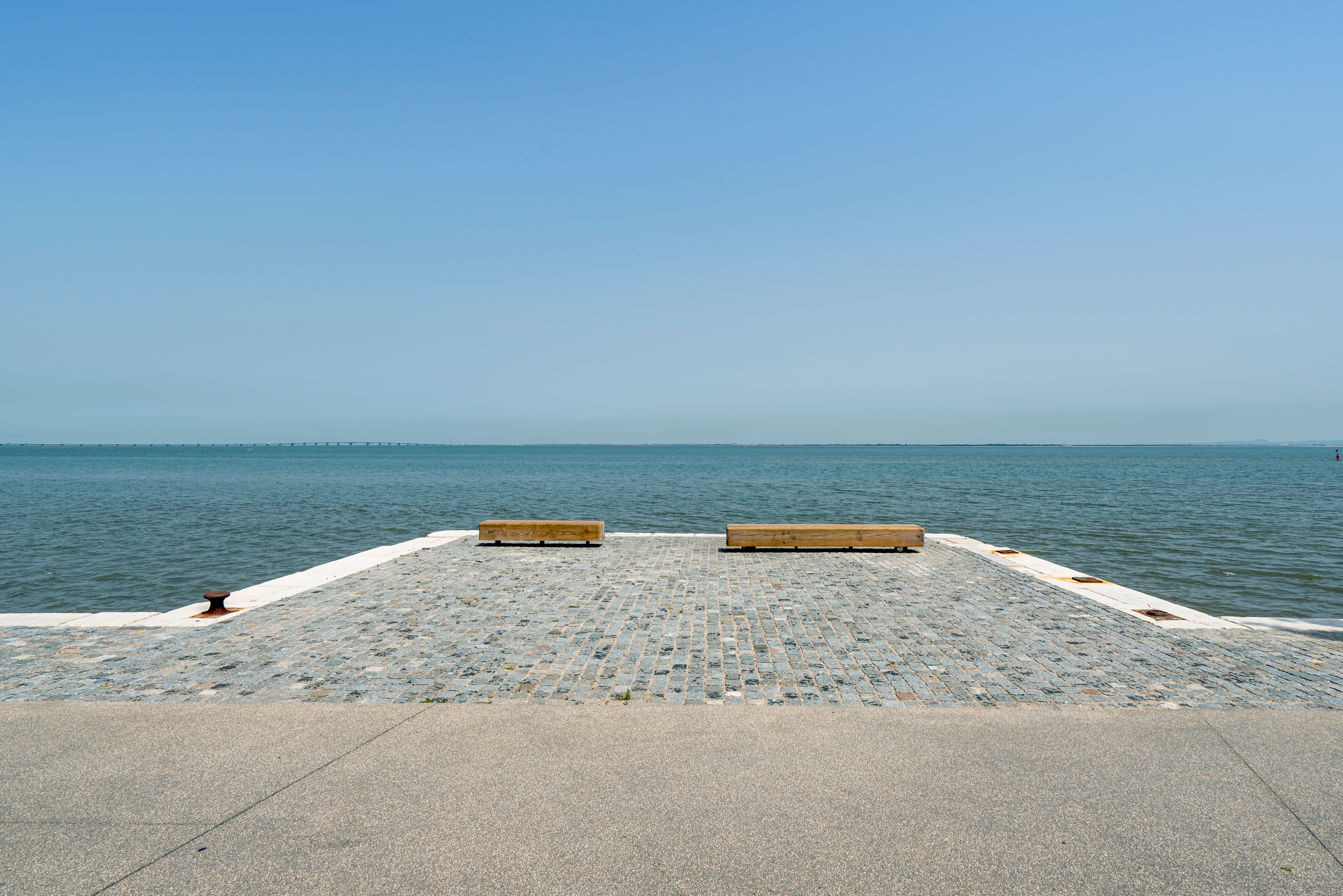 Serene Waterfront Jetty with Wooden Benches · Free Stock Photo