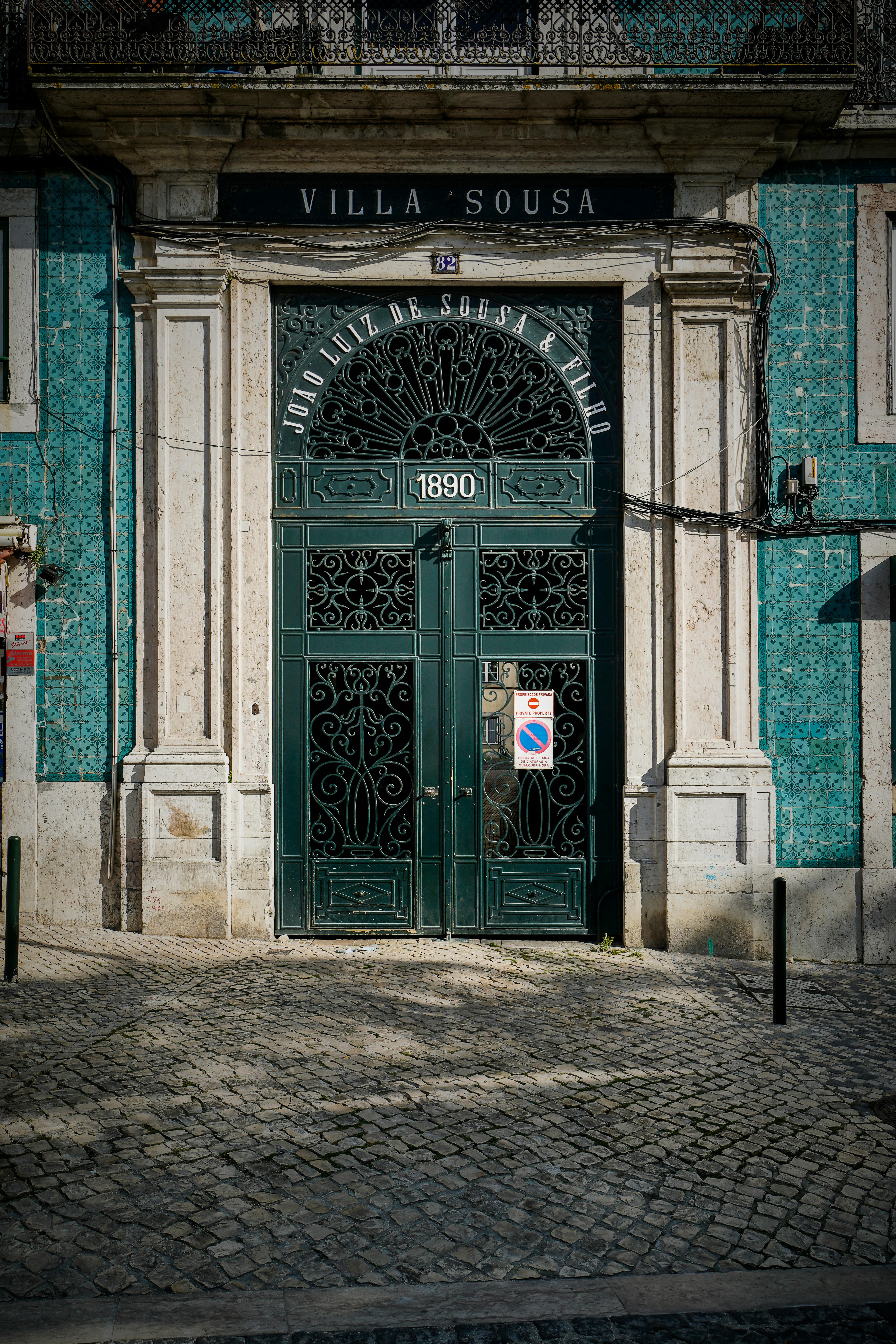 Ornate wrought iron door at Villa Sousa, showcasing historic Lisbon architecture.