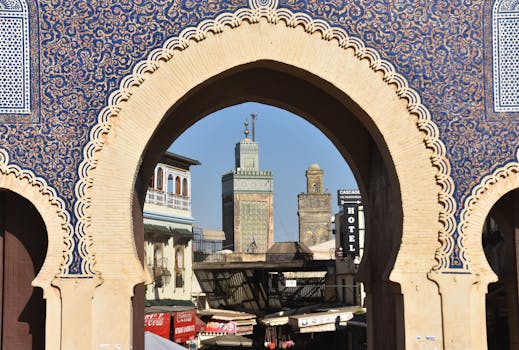 A view through Bab Bou Jeloud archway in Fès, revealing the city's historic architecture and skyline.