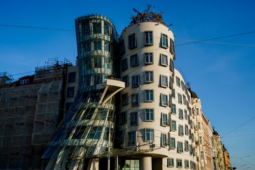 Free Iconic Dancing House in Prague with unique architecture under a clear blue sky. Stock Photo