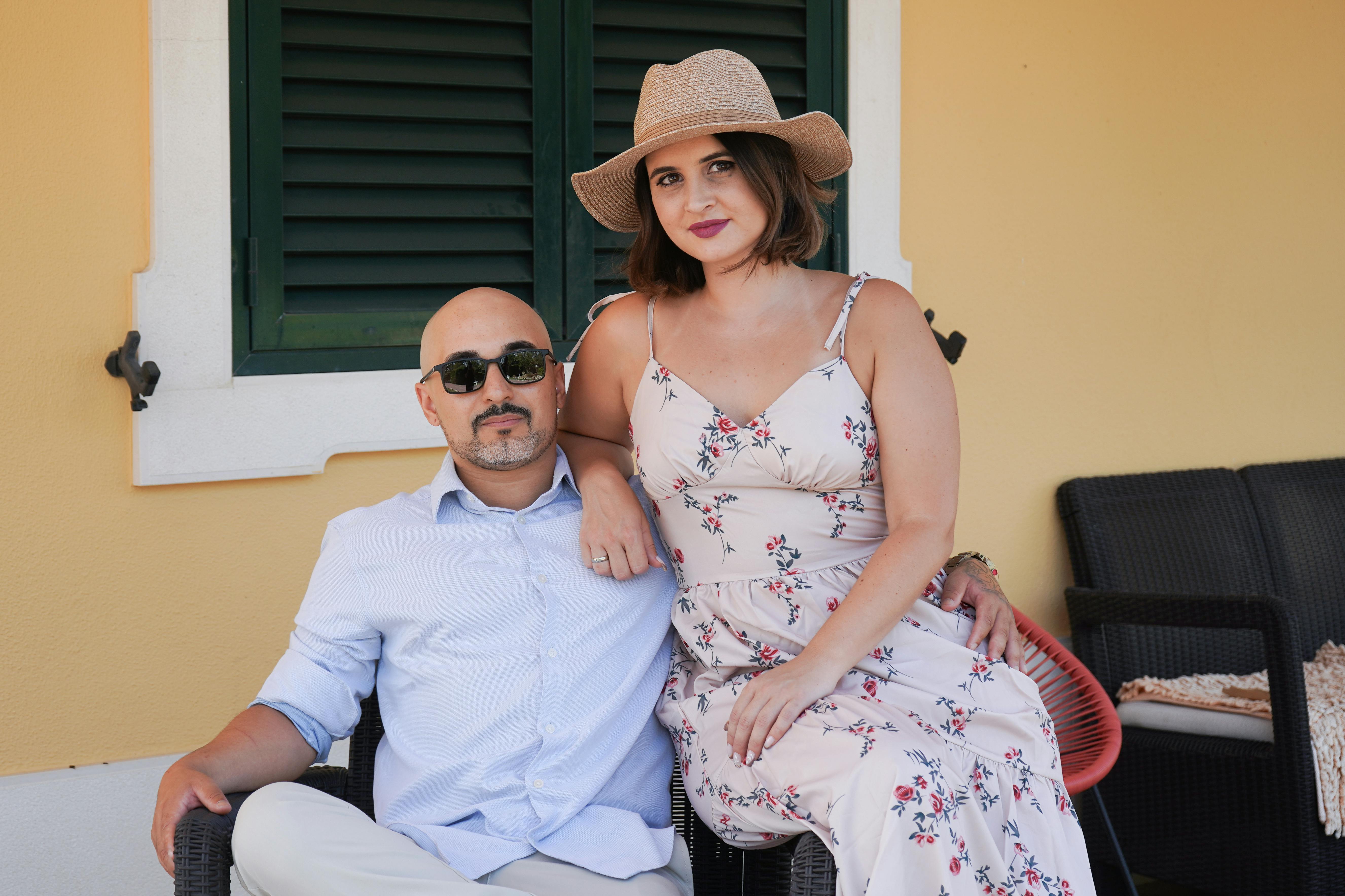 Free A couple enjoying a sunny day outdoors in Palmela, Portugal, seated together with a relaxed vibe. Stock Photo
