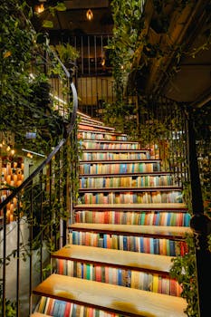 Colorful staircase adorned with books and lush greenery in a cozy indoor setting.