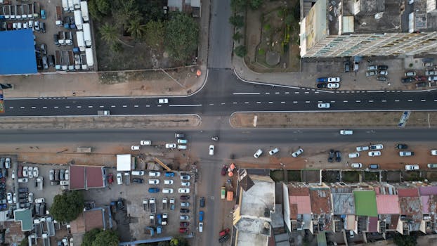 Overhead view of bustling city intersection with various vehicles, captured in Maputo, Mozambique, showcasing urban life.