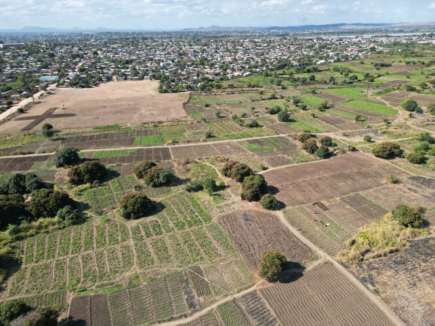 Expansive aerial view showcasing agricultural fields and rural landscape near Lilongwe, Malawi.
