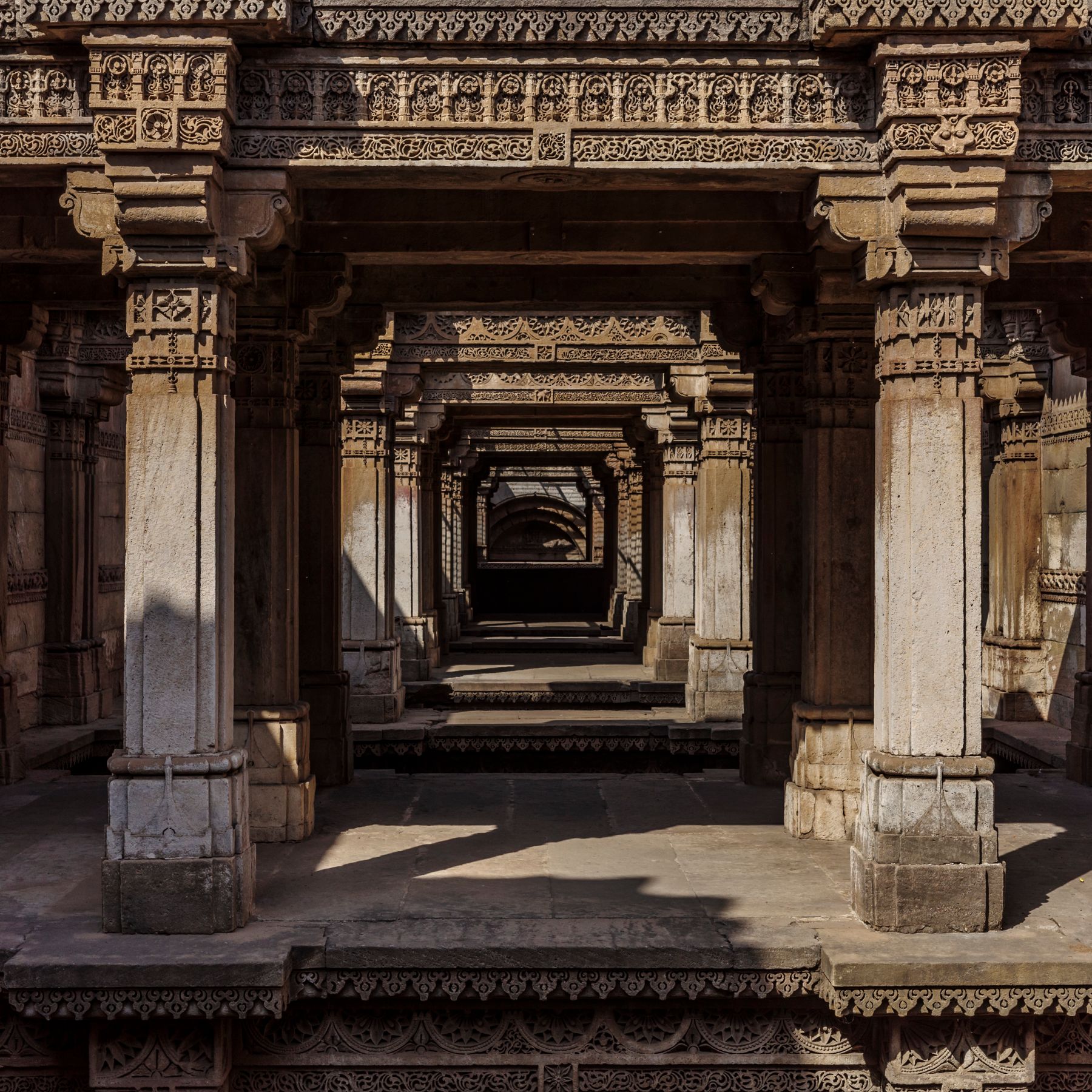 Carved wooden balconies leaning over a narrow lane in Ahmedabad's old city