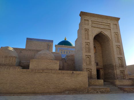 View of ancient Islamic architecture with a blue dome in Khiva, Uzbekistan.