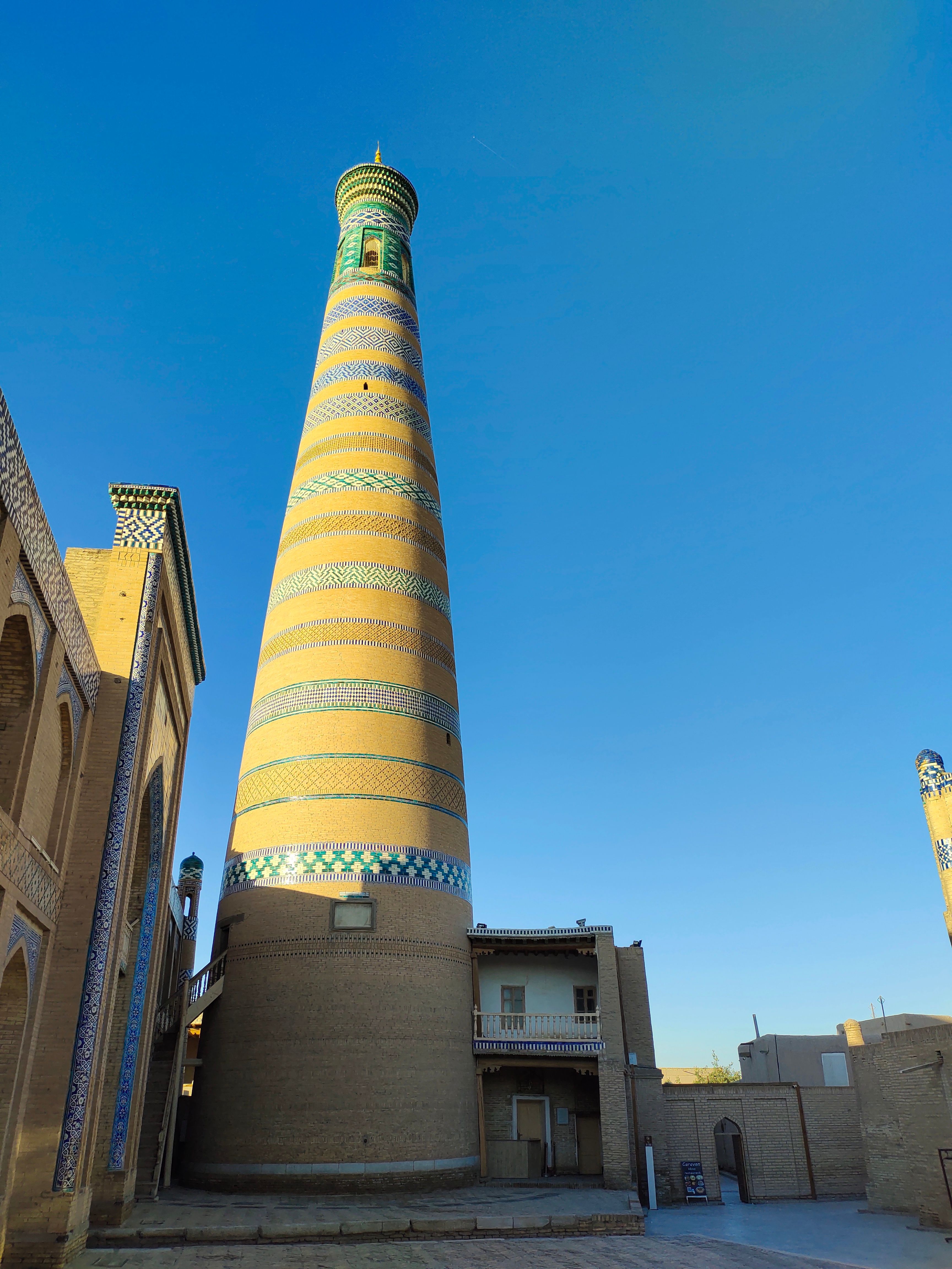 Stunning view of the iconic Islam Khodja Minaret in Khiva, showcasing its intricate tile work.