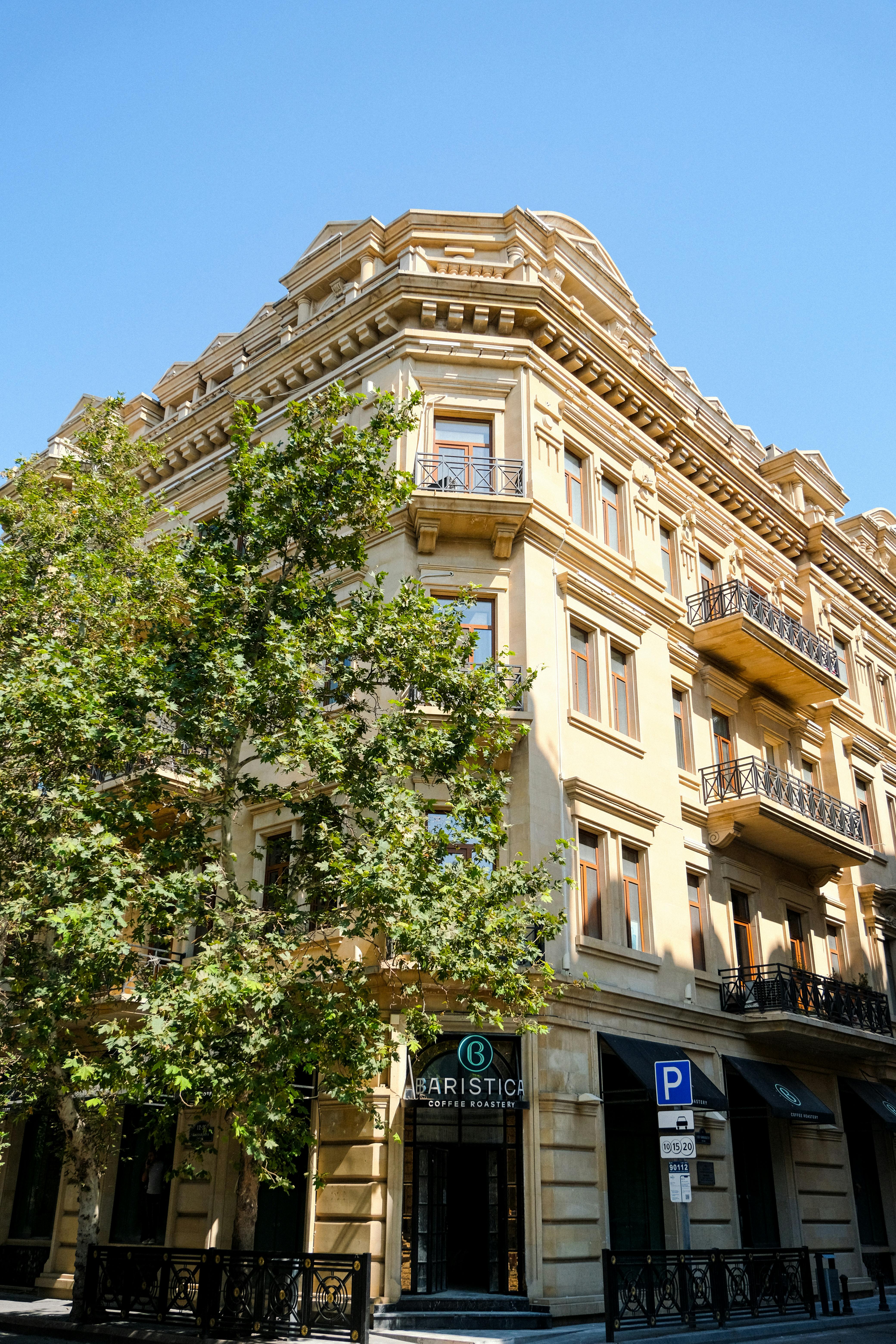 Free Architectural shot of a historic building with classic design under a clear blue sky. Stock Photo