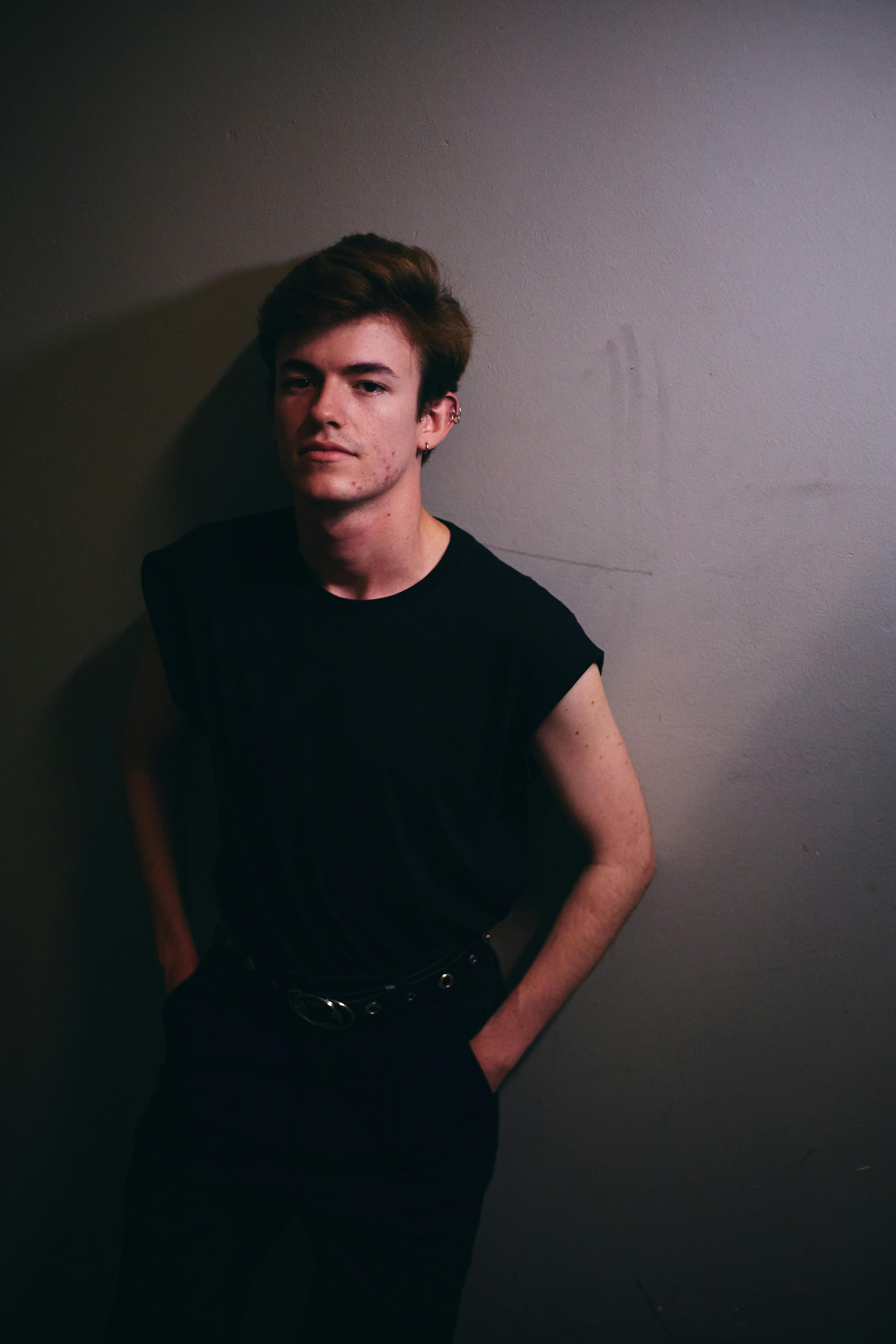 Portrait of a fashionable young man in Istanbul with a minimalist and moody atmosphere.